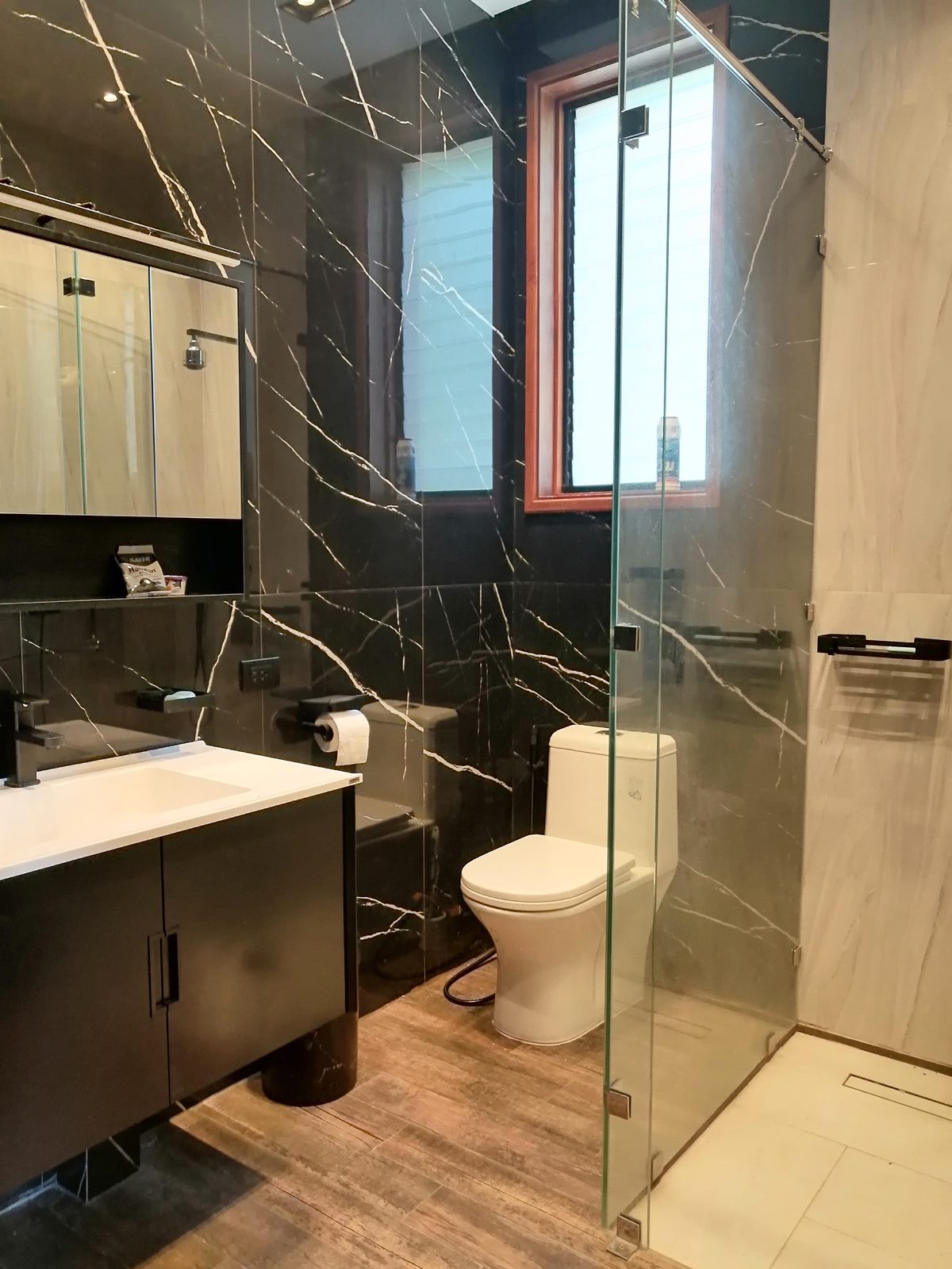 Bathroom — black marble, glass shower
