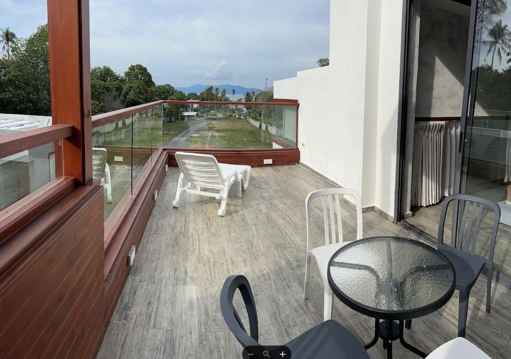 Rooftop balcony — open view, sun loungers